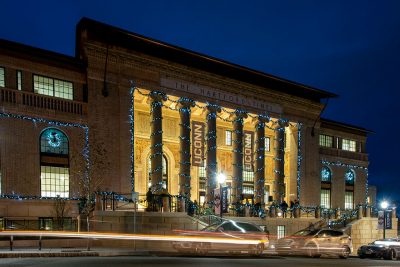 Hartford Times Building at UConn Hartford, lit up in blue lights during the holidays.